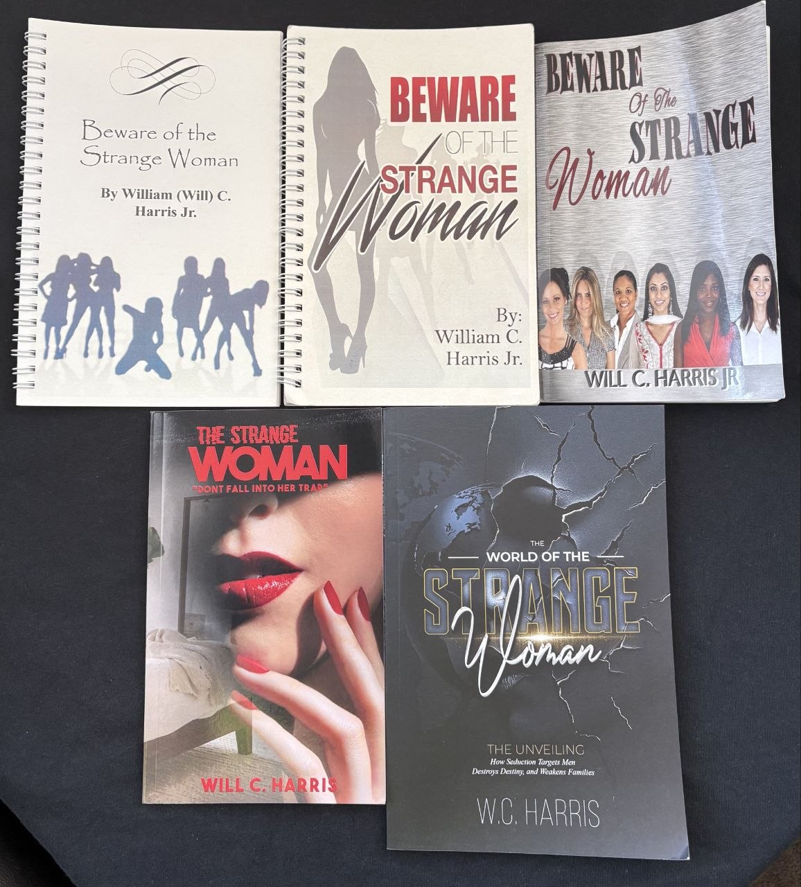 Five editions of The Strange Woman and The Unveiling by W.C. Harris, photographed together